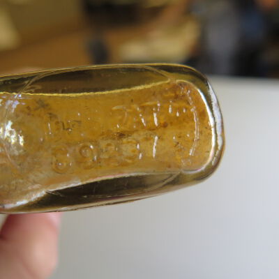 Bottom of bottle.: Origsize: 14" (h) x 2.5" (w) x; Origformat: Artifact