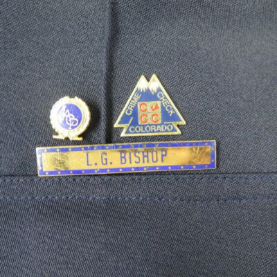 Close up of nametag and pins.: Origsize: 18" (w) x 33" (l); Origformat: Artifact
