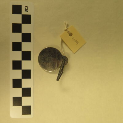 Back of tag.: Origsize: 1" (dia); Origformat: Artifact