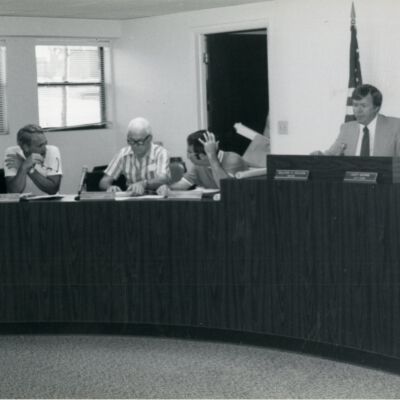 Several people siting around a meeting desk