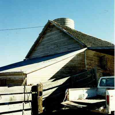 Silo on Brunner Property with a Building and a White Truck #2