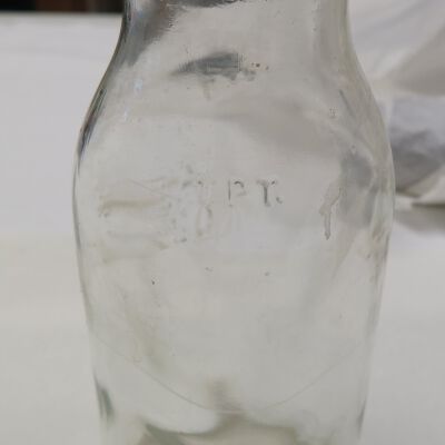 Side of milk bottle: Origsize: 7" (h) x 2.5" (w) x; Origformat: Artifact