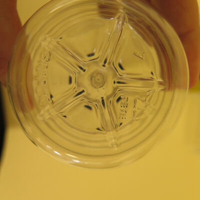 Bottom of water bottle.: Origsize: 9" (h) x 3" (w); Origformat: Artifact
