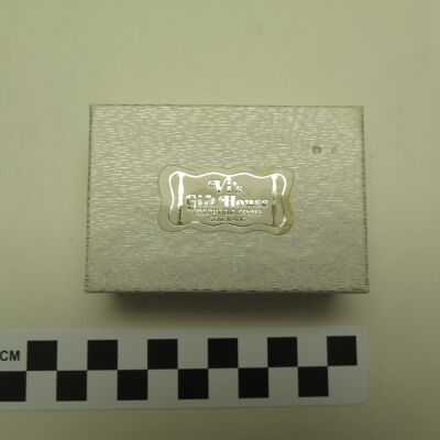 Close up of text on box.: Origsize: 1" (h) x 3" (w) x 2"; Origformat: Artifact