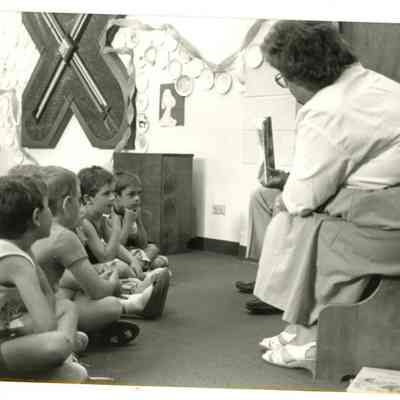 Charles Ozaki and Mary Jane Bailey Reading to Children