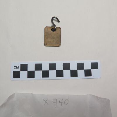 Back of tag.: Origsize: 0.5" (w) x 1" (l); Origformat: Artifact