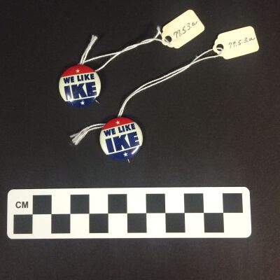 Front of two "We Like Ike" buttons.: Origformat: Artifact