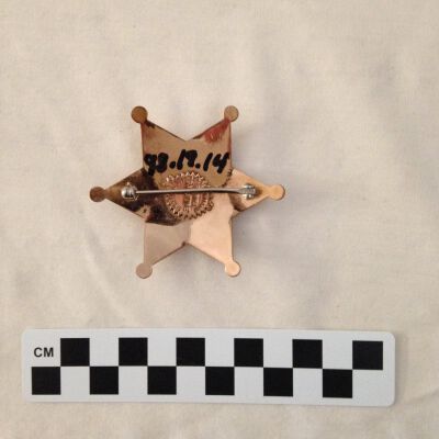 Back of badge.: Origsize: 3" (w) x 3" (l); Origformat: Artifact