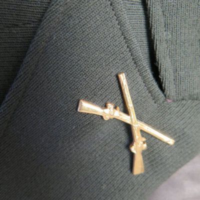 Close up of pin on jacket collar.: Origsize: 16.5" (w) x 32.5" (l; Origformat: Artifact