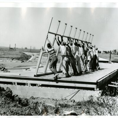People putting up the house frame