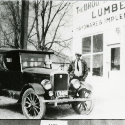 Man Standing by Car Outside Broomfield Lumber Company
