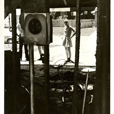 Young woman looking into building shell--under construction?