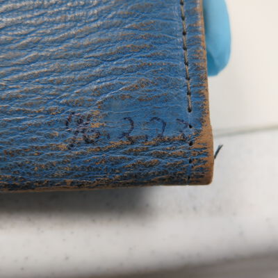 Number detail on wallet: Origsize: 3" (h) x 4.5" (w); Origformat: Artifact