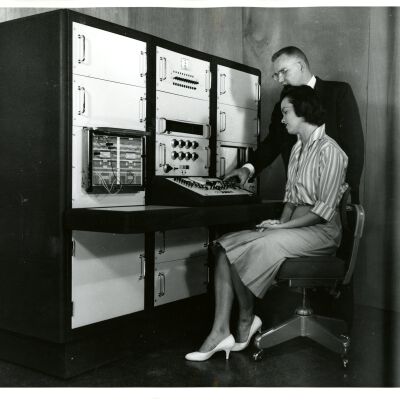 Man shows woman technology equipment