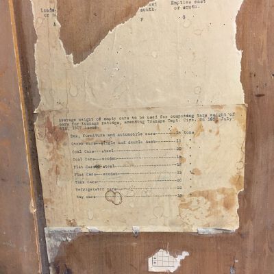 Remnants of paper with typing on back of door.: Origsize: 37.25 " (h) x 20" (w; Origformat: Artifact
