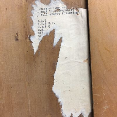 Remnants of paper with typing on back of door.: Origsize: 37.25 " (h) x 20" (w; Origformat: Artifact