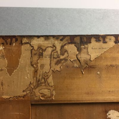 Detail of paper remnants with typing on back of door.: Origsize: 37.25 " (h) x 20" (w; Origformat: Artifact