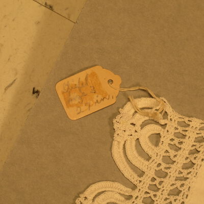 Tag on furniture scarf: Origsize: 9" (w) x 12" (l); Origformat: Artifact