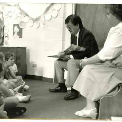 Charles Ozaki and Mary Jane Bailey Reading to Children