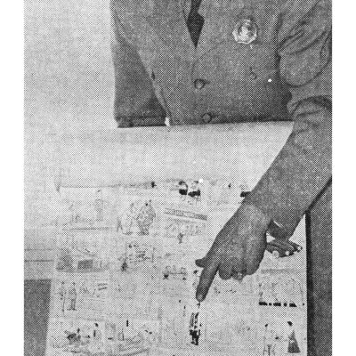 Tollbooth Worker Pointing at Something on a Poster
