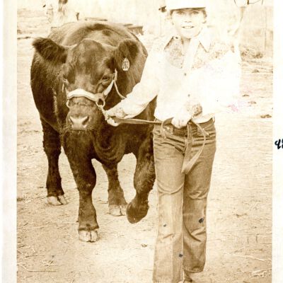 "First Year Winner" - Child holding young bull