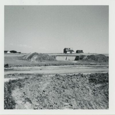Dirt road with new Broomfield depot foundation/basement in background, 1976: Origsize: 3.5" x 3.5"; Origformat: Print-Photographic; Resolution: 1500dpi