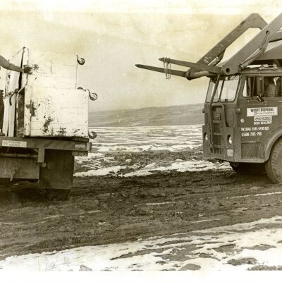 Broomfield Sanitary Workmen - Loading the last of Waste Disposal's equipment at the Broomfield Sanitary Landfill - 1973