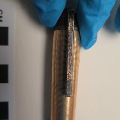 Close up of text on pen clip.: Origsize: 5" (l) x 0.25" (dia); Origformat: Artifact