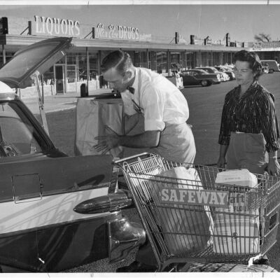 Safeway Store Clerk Helping Woman Load Station Wagon