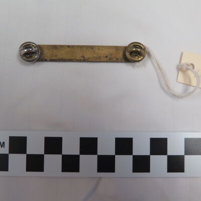 Back of nametag.: Origsize: 2.5" (w) x 0.25" (l); Origformat: Artifact