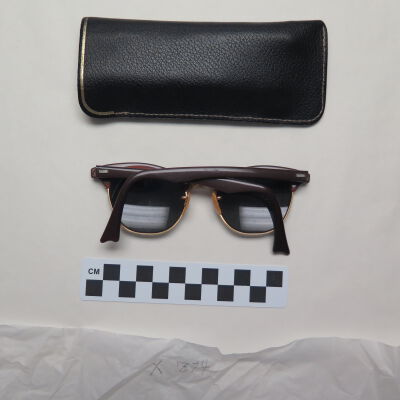 Back of sunglasses and case.: Origsize: 3" (h) x 1.25" (w) x; Origformat: Artifact