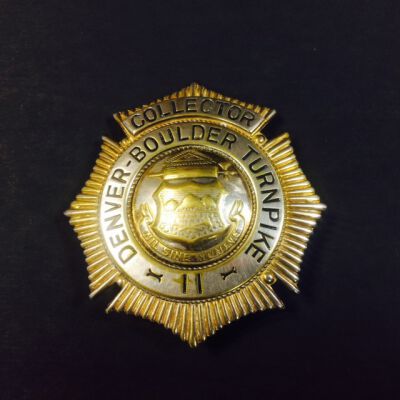 Close Up of Front of Badge: Origsize: 2 1/2" (L) x 2" (W); Origformat: Artifact