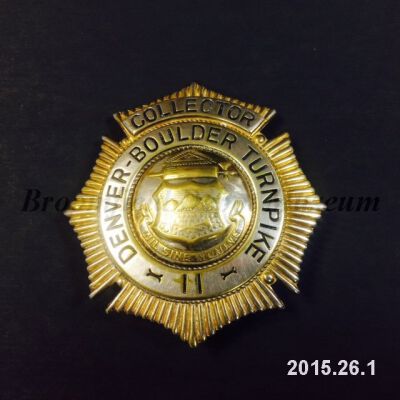 Badge with Watermark and Object ID Stamp: Origsize: 2 1/2" (L) x 2" (W); Origformat: Artifact