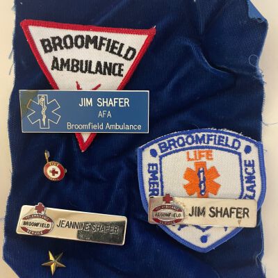 Nametags, patches, and pin belonging to Jim and Jeannine Schafer