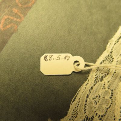 Close up of number on doily.: Origsize: 10.5" (w) x 18" (l); Origformat: Artifact