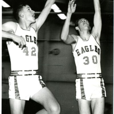 Broomfield Eagles High School Basketball - two players reaching toward net