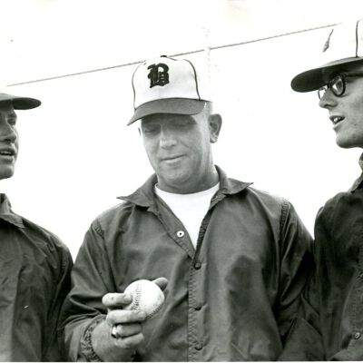 Broomfield Eagles Baseball - three men; man in middle holding baseball