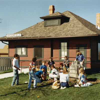 Kids Gathered by the Broomfield Historical Depot Sign and Museum