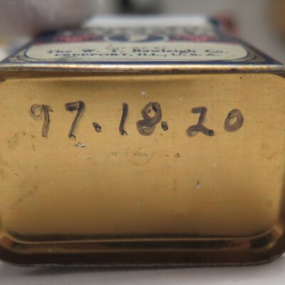 Bottom of tin: Origsize: 3" (h) x 2.25" (w) x; Origformat: Artifact