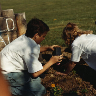 Kids Planting Near the Broomfield Historical Depot Sign