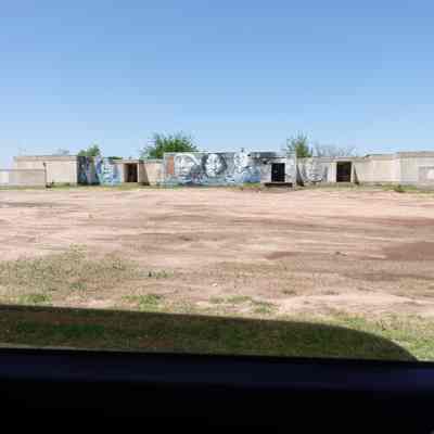 Boarding school for native children in Concho. A mural has been painted on the dilapidated building portraying the hope and resilience of native people.: May 2022