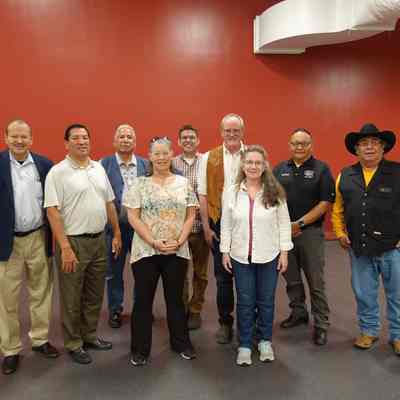 Delegation from Broomfield and tribal council with Governor Reggie Wassina and Lieutenant Governor Gilbert Miles. Chester Whiteman (Cultural Coordinator) is in the black cowboy hat to the right. Frank Medicine Water (Cultural Coordinator) is fourth from left. David Allison in middle. Lori Lane middle left, Alietta Remillard middle right, Tim Harmos fourth from right.: May 2022