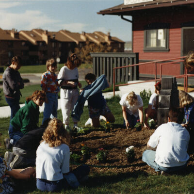 Kids Planting Near the Broomfield Historical Depot Sign and Museum