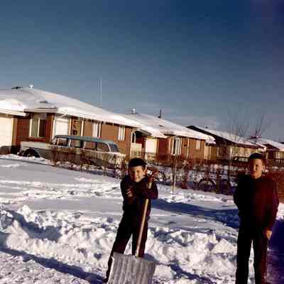 Boys shoveling a driveway