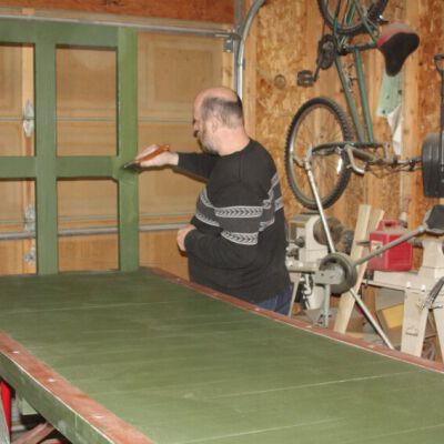 Condition: Volunteer painting the reconstucted missing luggage stop. (2018-03-03): Origformat: Artifact