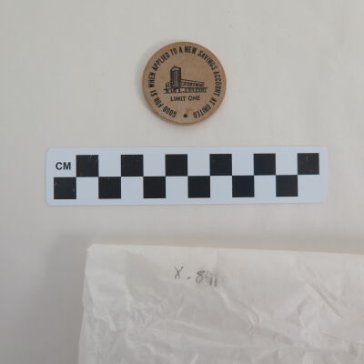 Back of wooden nickel.: Origsize: 1.5" (dia); Origformat: Artifact