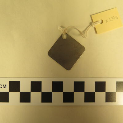 Back of tag.: Origsize: 1.5" (w) x 1.5" (l); Origformat: Artifact