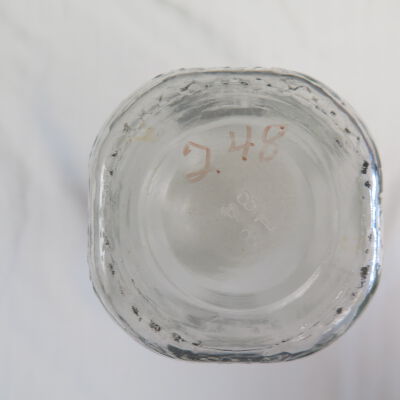 Bottom of milk bottle.: Origsize: 8.5" (h) x 3.5" (w); Origformat: Artifact