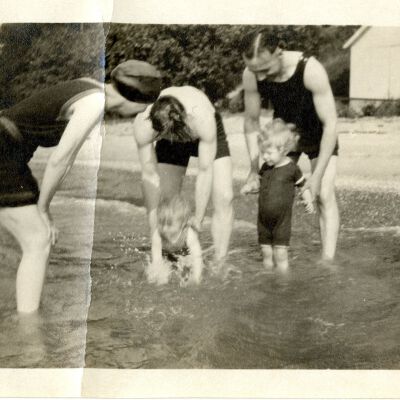 Men, women, and children in swimsuits