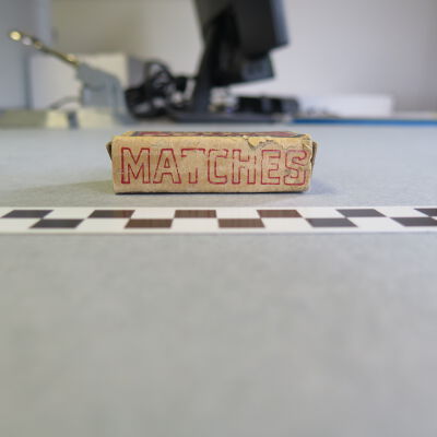 Side of the matchbox: Origsize: 0.75" (h) x 1.5" (w); Origformat: Artifact